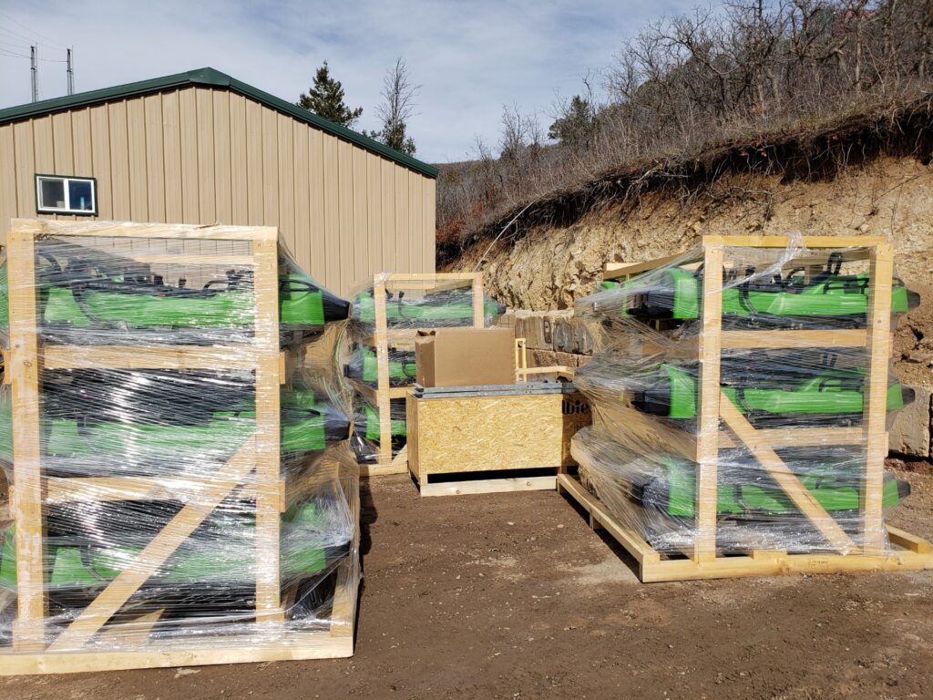 Unpacking day for new green Alpine Coaster sleds
